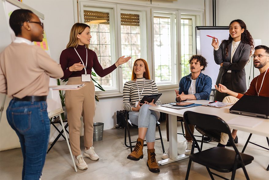 Two professionals presenting results to their team