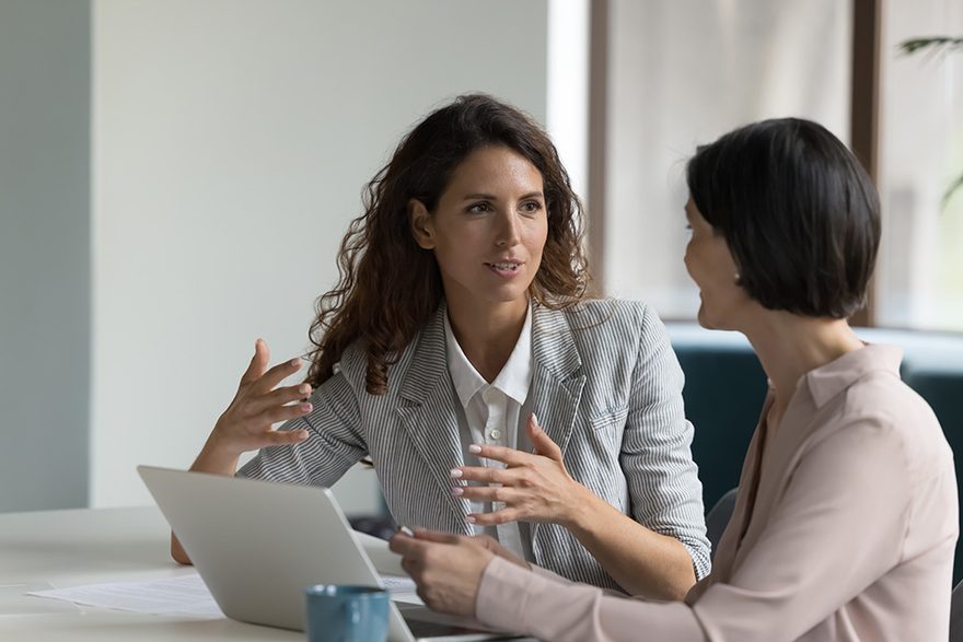 Two colleagues discussing project details